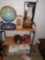 Shelf unit with contents including baseball mitt, lamps, and glasses