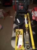 Tool lot including jumper box, volt tester, extension pole, shop light,and wood plane