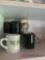 Coffee mugs measuring cups middle shelf of the cabinet