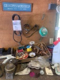 Contents of top of the tool bench in garage electrical tape measures wire and miscellaneous