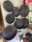 Seven cast iron pans in rec room