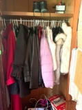 Contents of coat closet ladies coats books and other miscellaneous