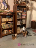 Two bookshelves with books and radios