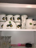 Cabinet full of glasses and John deer set