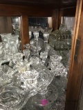 Shelf of crystal glassware butter dishes/ candle holders/ salt and peppers