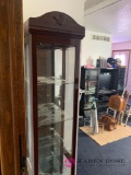 Skinny tall glass shelf curio cabinet doors open from the side
