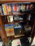 Cabinet contents including VHS tapes and books and cassettes