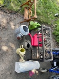 Miscellaneous lot with gas stove, sprinkler cans, mailbox, and craft swing. Garage location