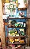 Shelf with contents including John Deere Deco, toy trucks, lamp and clock. Barn location