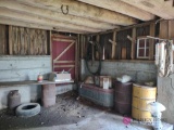 Bird feeders, water trough, and drums in barn