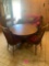 Round wooden table with four chairs