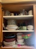 Kitchen cabinet contents plates bowls coffee mugs and miscellaneous