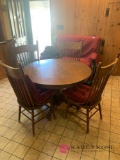 Round wooden table with four chairs