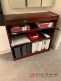 Bookcase with office supplies in/check out office area