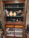 contents of cabinet including a lot of miniature dollhouse books. BS