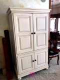 Creamy white wooden entertainment center