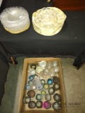 box of candle holders, glasses, and plates