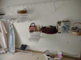 miscellaneous items on shelf and floor including ironing board. master bedroom closet