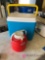 Cooler and 1 gallon jug in garage