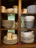 Kitchen cabinet of dinner plates and coffee cups