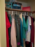 Contents of upstairs closet ladies clothes and board games in B4