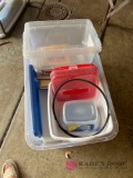 Tote of books and containers in garage