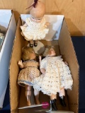 Three porcelain dolls with crocheted dresses