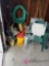 Garage light green plastic chairs plastic table hose gardening tools birdfeeders and lots of