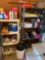 Metal and plastic shelves with contents cooler bug spray cleaners thermos umbrellas and