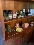 Two shelves of knickknacks candles and more