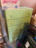 Green painted dresser in garage