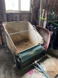 Grass sweeper and wheel barrel in shed
