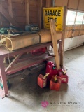 59 inch long metal workbench with miscellaneous gas cans battery charger and more in shed
