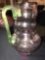 Pink pitcher with green handle