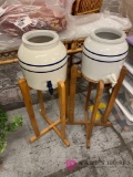 two matching water jugs on stands