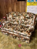 love seat with bird print in basement bring help to load