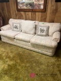 cream colored sleeper sofa in basement bring help to load