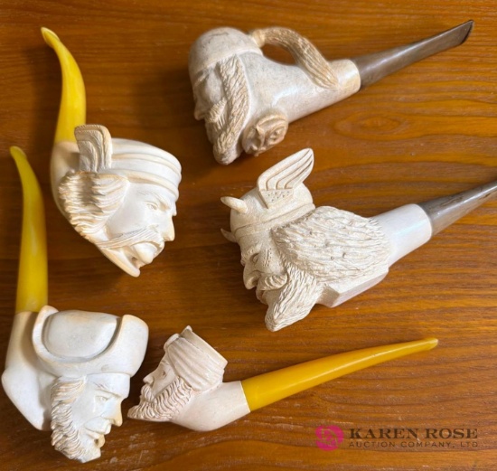 five white carved pipes