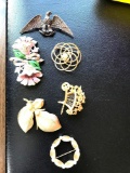 Six costume jewelry pins