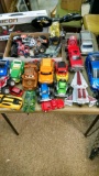 Large lot of toys including Spider-Man figurine, trucks, and cars