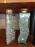 Decorative glass bottles and box of bathroom supplies