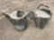 Two galvanized metal watering cans