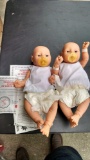 Two newborn baby dolls with certificates