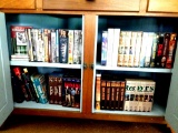 Assortment of VHS, DVD and books.