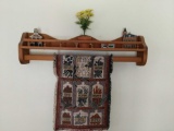 Decorative wooden shelf, with contents and quilt