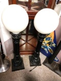 Two 44 in tall cast iron pedestal lamps