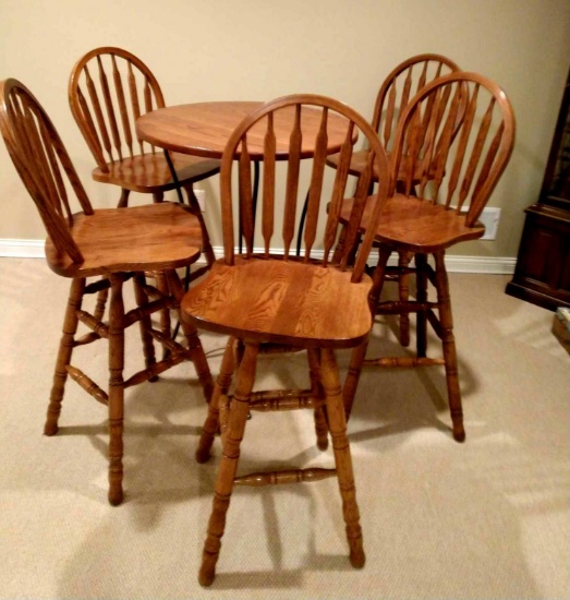 30 in high top oak table with 5 swivel oak chairs