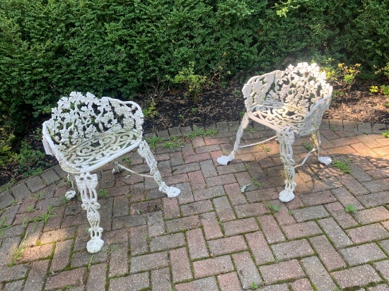 Two cast metal yard chairs