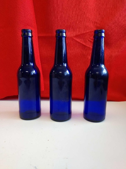 3 blue glass bottles