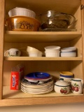 Contents of kitchen cabinet plates plastic plates cream and sugar small dishes and baking dishes